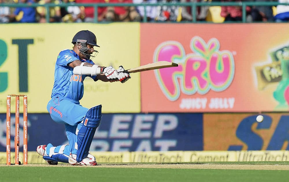 Shikhar Dhawan plays a shot during the India- West Indies One Day International match, in Dharamshala.