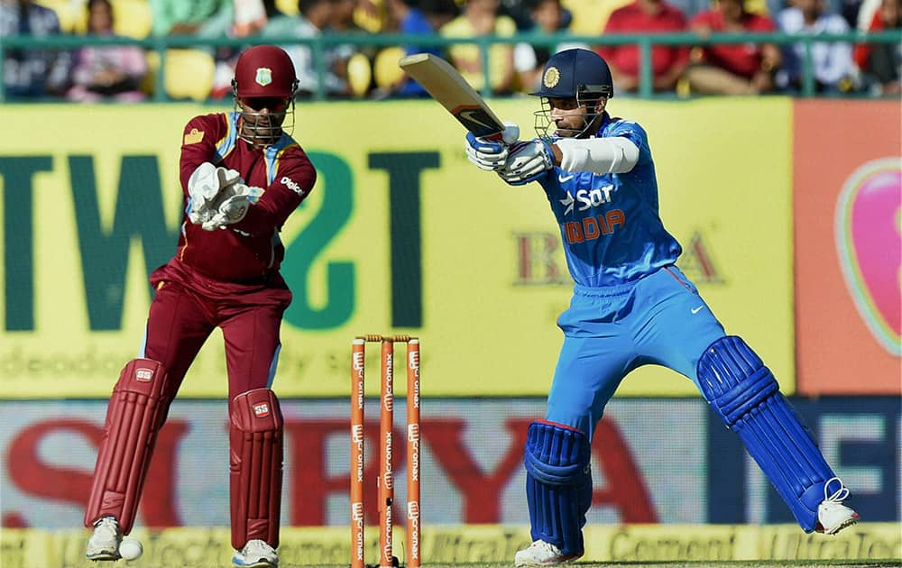  Indian batsman Ajinkya Rahane plays a shot during 4th ODI match against West Indies in Dharamshala.