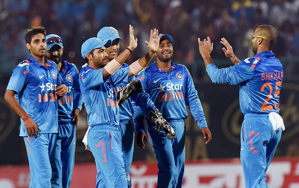 Indian players celebrate the dismissal of West Indies batsman K Pollard during their ODI match, in Dharamshala.