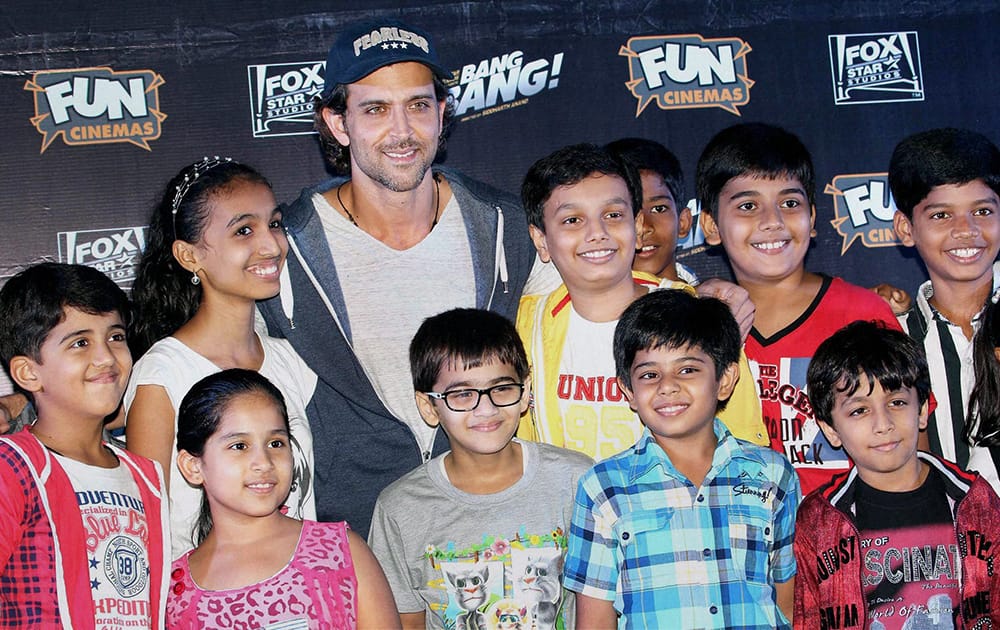 Bollywood actor Hrithik Roshan with kids during the special screening of film Bang Bang in Mumbai.