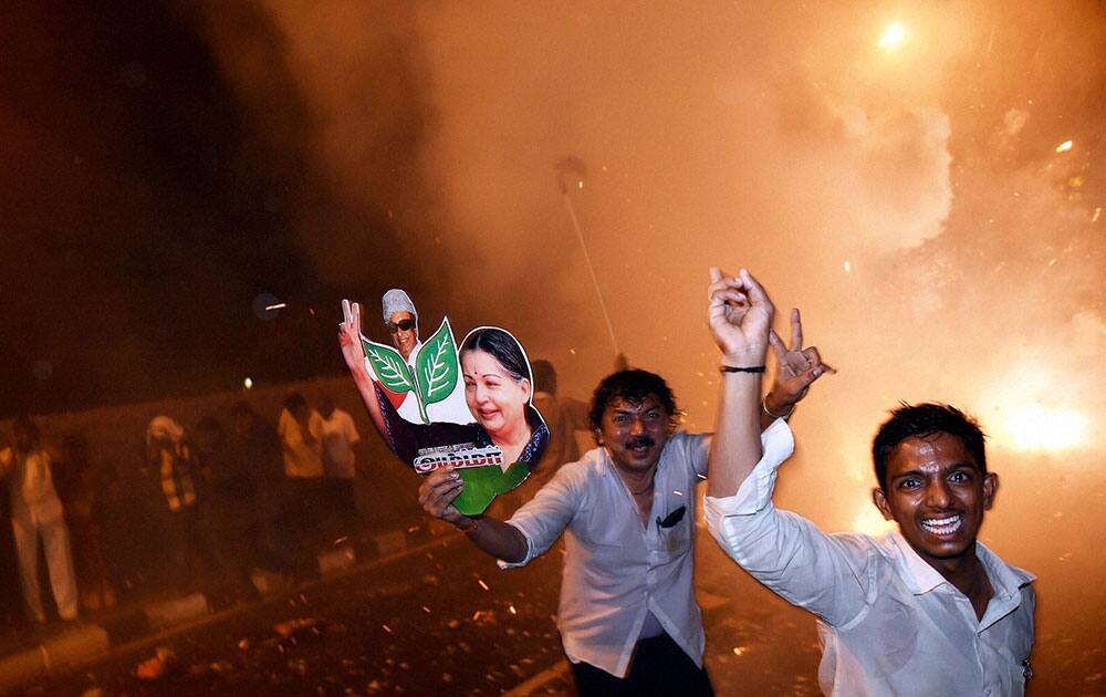 AIADMK supporters celebrate after J Jayalalithas release from jail on bail granted by Supreme Court.