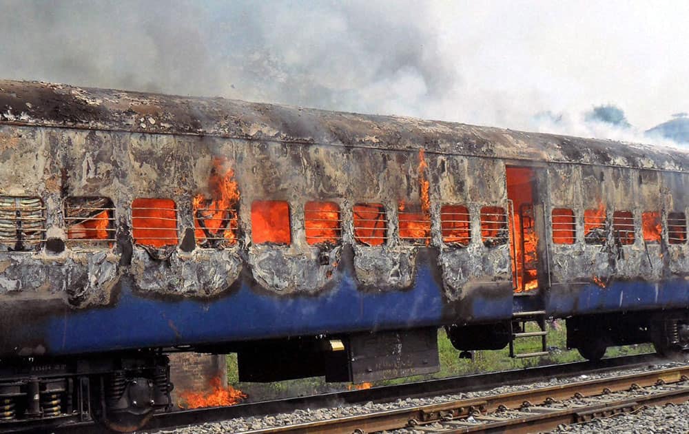 An Army Special Train in flames after its coaches caught fire at Chowki Railway Station.
