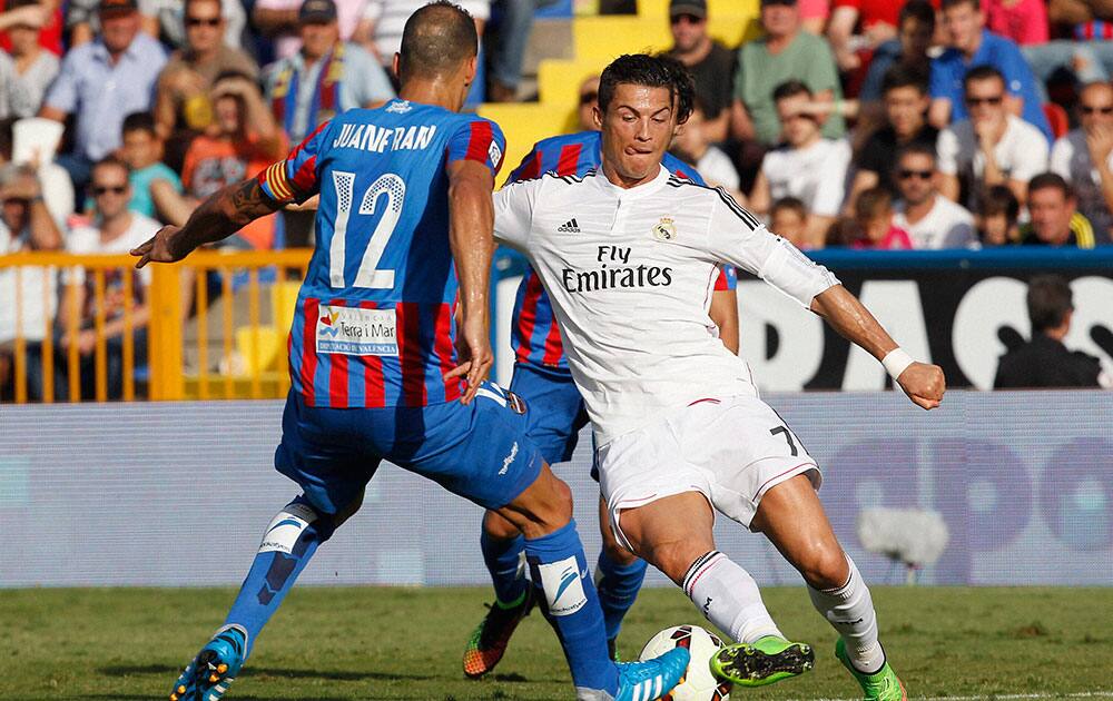 Real Madrids Cristiano Ronaldo, right, from Portugal duels for the ball with Levantes JuanFran Garcia during a Spanish La Liga soccer match at the Ciutat de Valencia stadium in Valencia, Spain.
