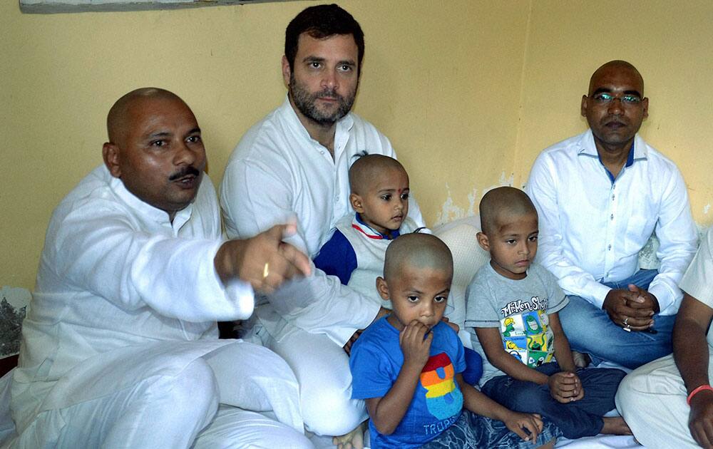 Congress Vice-president Rahul Gandhi with the family members of deceased former MLA Ram Sewak at his ancestral home at Musafirkhana in Amethi.