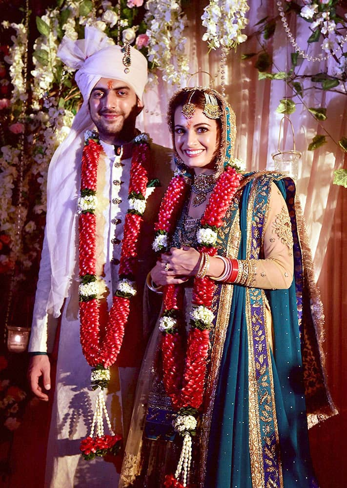 Bollywood actress Dia Mirza poses with her husband Sahil Sangha after their marriage.