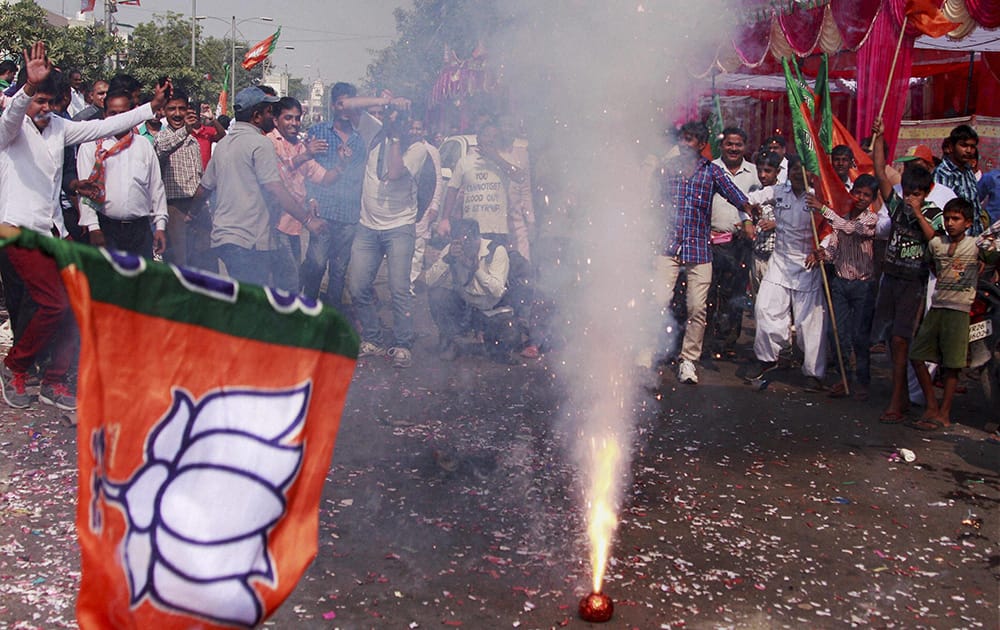 BJP workers burst crackers while celebrating the party victory in the Assembly polls in Gurgaon.