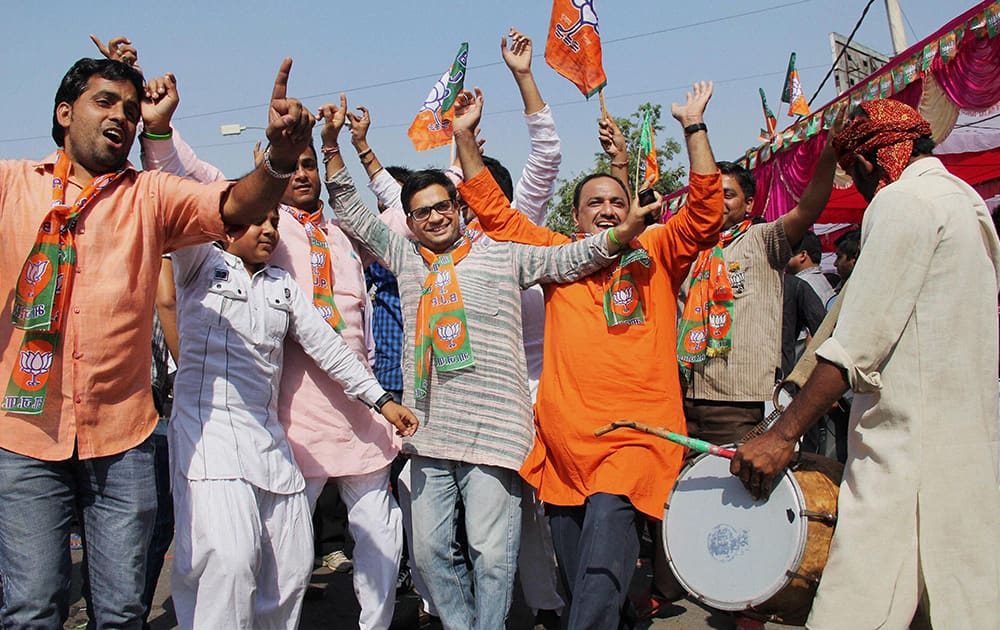 BJP workers dance while celebrating the party victory in the Assembly polls in Gurgaon.