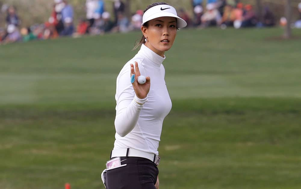 Michelle Wie of the United States reacts after sinking a birdie putt on the 18th hole during the final round of the KEB Hana Bank Championship golf tournament at Sky72 Golf Club in Incheon, South Korea.