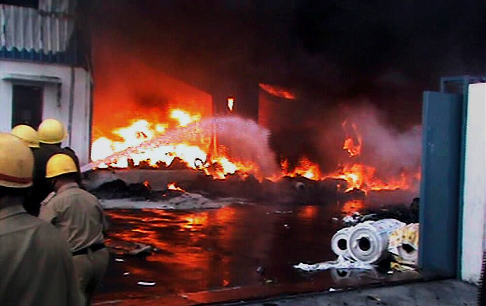 Fire fighters try to douse fire, which broke out at a plastic factory at Dankuni in Hooghly.