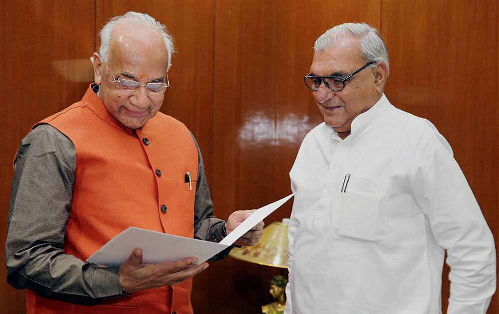 Haryana Chief Minister Bhupinder Singh Hooda calls on Governor Kaptan Singh Solanki at Haryana Raj Bhawan in Chandigarh on Sunday to submit his resignation.