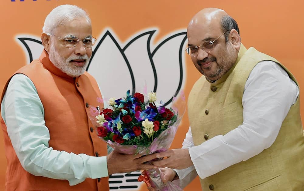 PM Narendra Modi being welcomed by BJP President Amit Shah during the partys parliamentary board meeting to assess the assembly poll results.