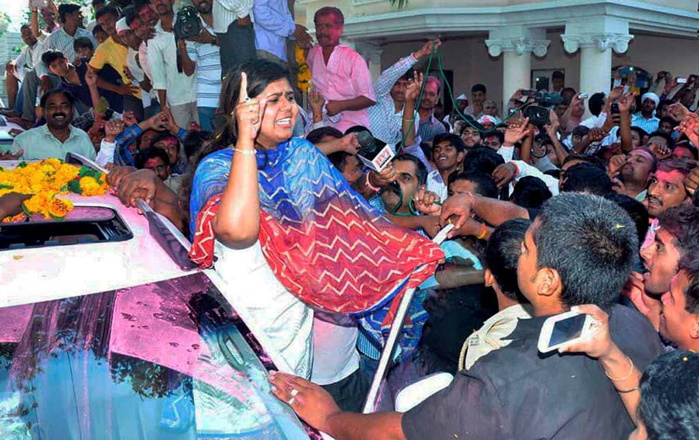 BJP candidate Pankaja Munde celebrates her victory with party workers in the Assembly elections in Parli.