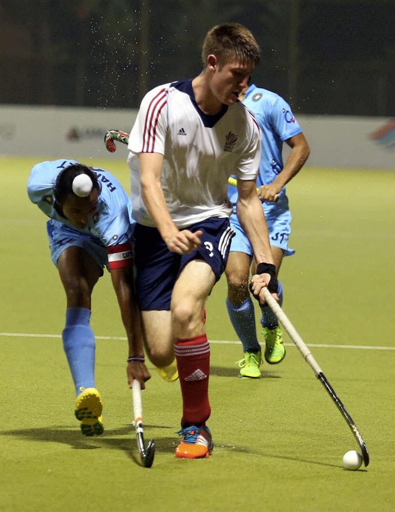 Indian Hockey players vie for the ball during final of the Sultan of Johor Cup 2014 by defeating Great Britain, in Johor Bahru.