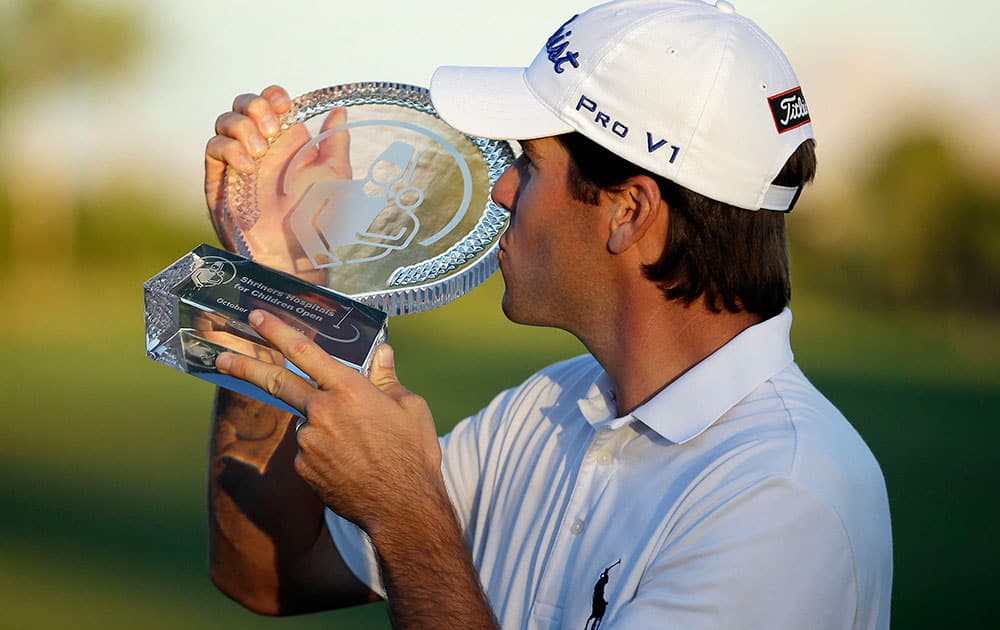 Ben Martin kisses the trophy after winning the Shriners Hospitals for Children Open golf tournament.