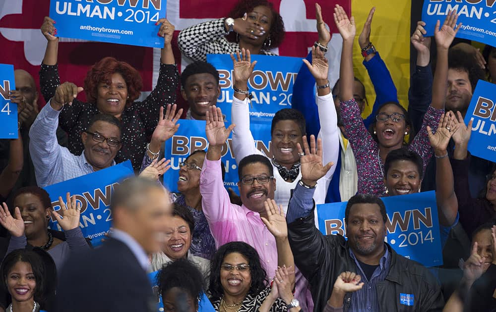 President Barack Obama is applauded as he campaigns for Maryland Gubernatorial Democrat candidate Lt. Governor Anthony Brown at an Early Vote Rally at Dr. Henry Wise High School in Upper Marlboro, Md.