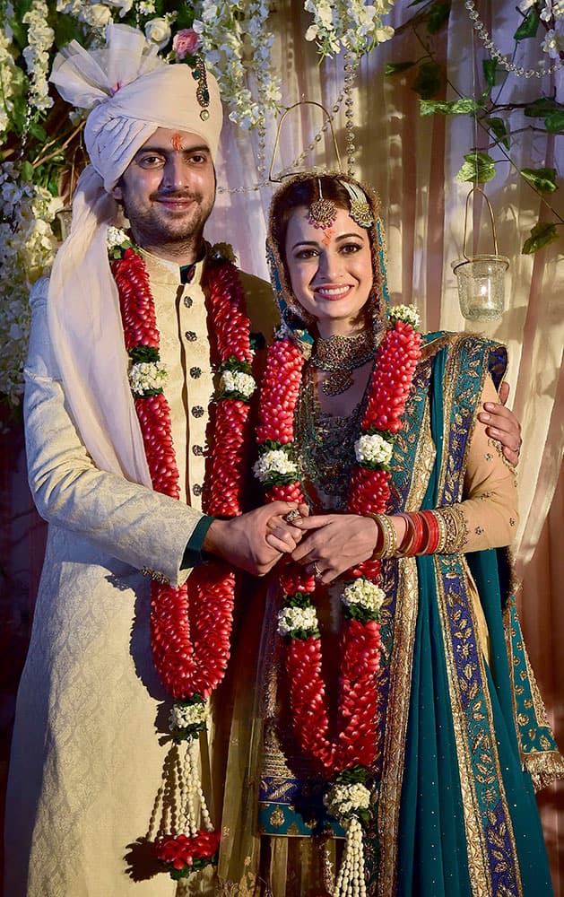 Bollywood actress Dia Mirza poses with her long-time beau Sahil Sangha after she got married in New Delhi.
