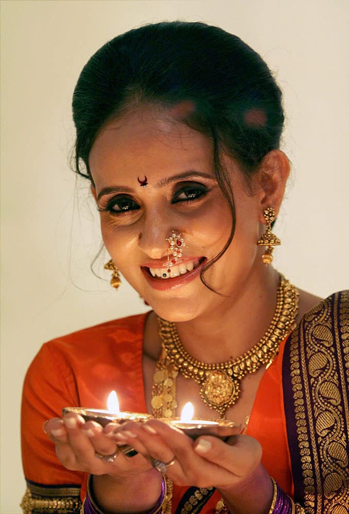 Bollywood Actress Shweta Khanduri poses with diya during a celebration of ‘Diwali’ festival, in Mumbai.