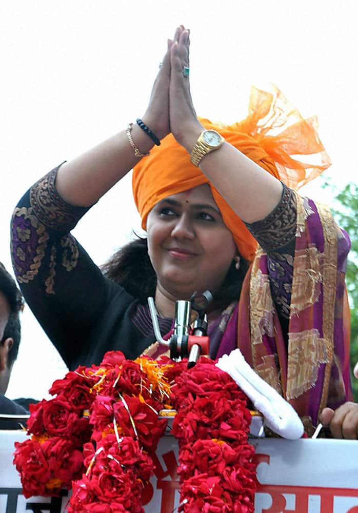 BJP candidate Pankaja Munde greets her supporters as she celebrates her victory in the Assembly elections in Parli.