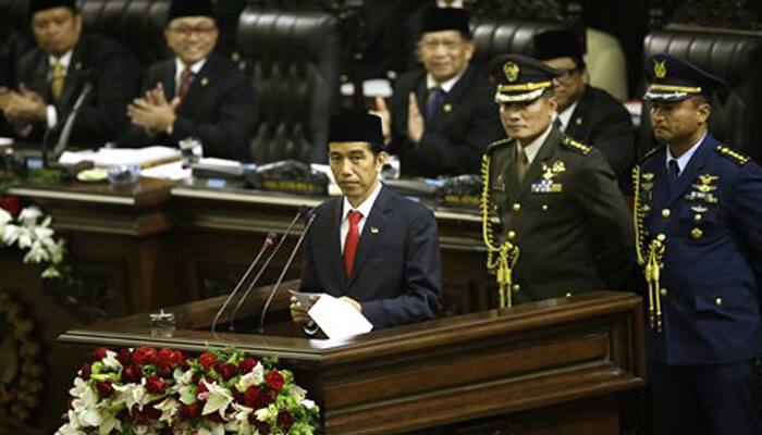 Indonesia`s Widodo takes office, reaches out to foes