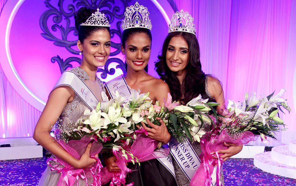 (L-R) Asha Bhat, Miss Diva Universe 2014 2nd runner up, Noyonita Lodh, Miss Diva Universe 2014 winner, Alankrita Sahai, Miss Diva Universe 2014 1st runner up pose after being crowned in Mumbai.