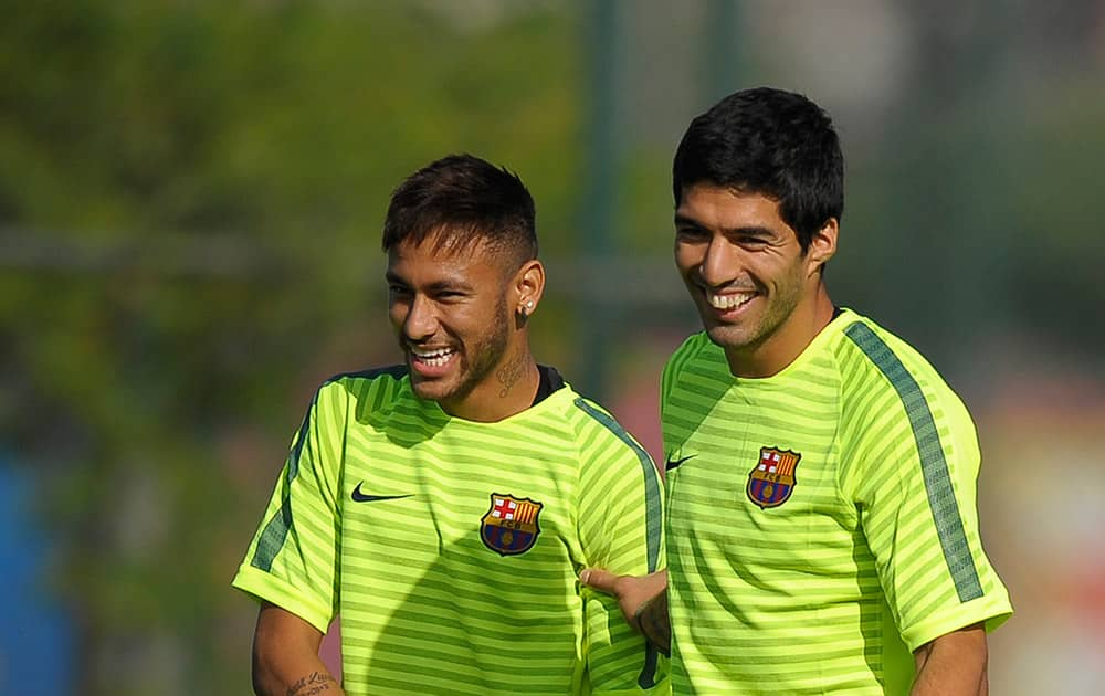 FC Barcelona's Luis Suarez, from Uruguay,and Neymar, from Brazil, attend a training session at the Sports Center FC Barcelona Joan Gamper in San Joan Despi, Spain.