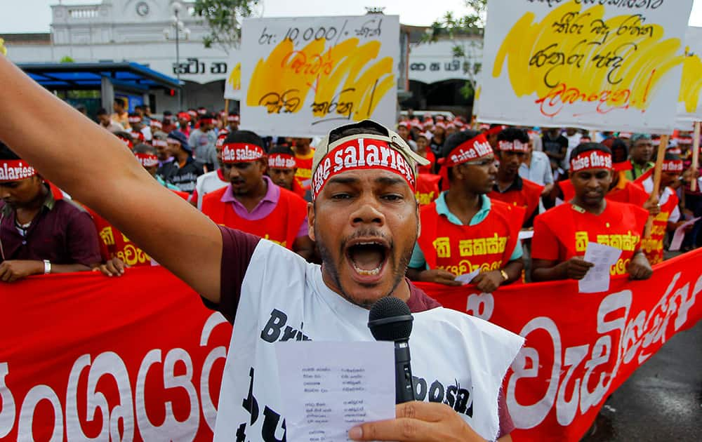 A Sri Lankan trade union activist shouts slogans during a protest demanding that the salaries of workers in the public as well as private sector be increased in the next year’s budget in Colombo, Sri Lanka.