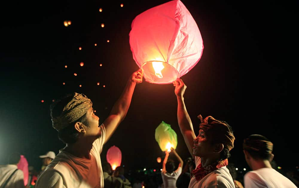 Supporters of Indonesian President Joko Widodo lifts paper lanterns before releasing into the air during a celebration after Widodo's inauguration as the country's seventh president in Bali, Indonesia.