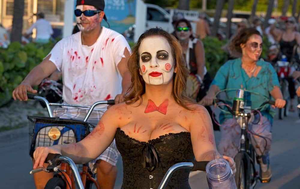 Participants in the Zombie Bike Ride roll down a street in Key West, Fla. The event attracted some 7,000 ghoulish-garbed riders and coincided with Key West's annual Fantasy Fest costuming and masking festival that continues through Sunday, Oct. 26.