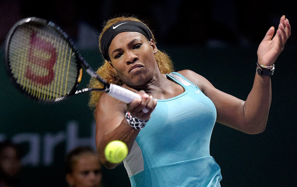 Serena Williams of the U.S. returns a shot against Ana Ivanovic of Serbia during their singles tennis match at the WTA Finals in Singapore. Williams won her opening match at the WTA Finals on Monday, beating Ivanovic 6-4, 6-4 in the Red Group for her 16th consecutive victory at the season-ending tournament.