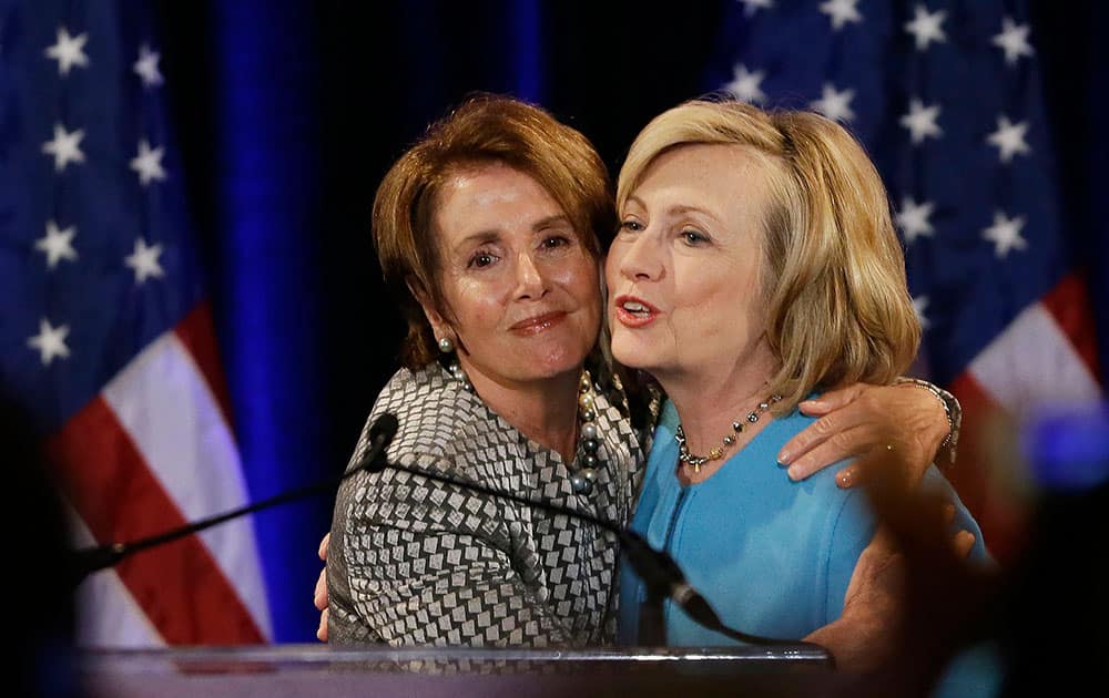 Former Secretary of State Hillary Rodham Clinton, right, is embraced by House Minority Leader Nancy Pelosi, left, before speaking at a fundraiser for Democratic congressional candidates hosted by Pelosi at the Fairmont Hotel,  in San Francisco. 