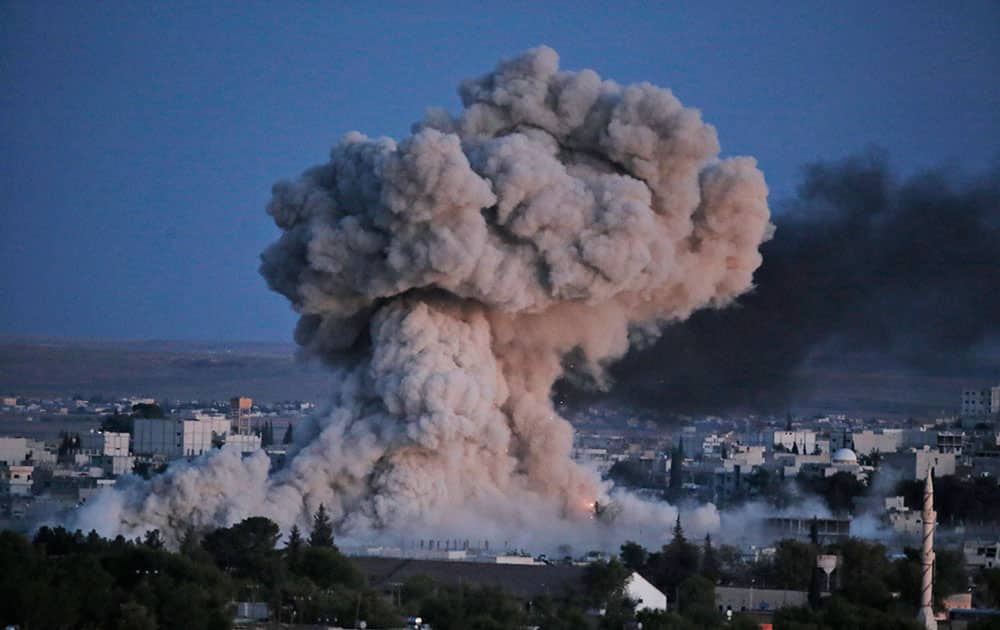 Thick smoke from an airstrike by the US-led coalition rises in Kobani, Syria, as seen from a hilltop on the outskirts of Suruc, at the Turkey-Syria border, Monday, Oct. 20, 2014 Kobani, also known as Ayn Arab, and its surrounding areas, has been under assault by extremists of the Islamic State group since mid-September and is being defended by Kurdish fighters. 
