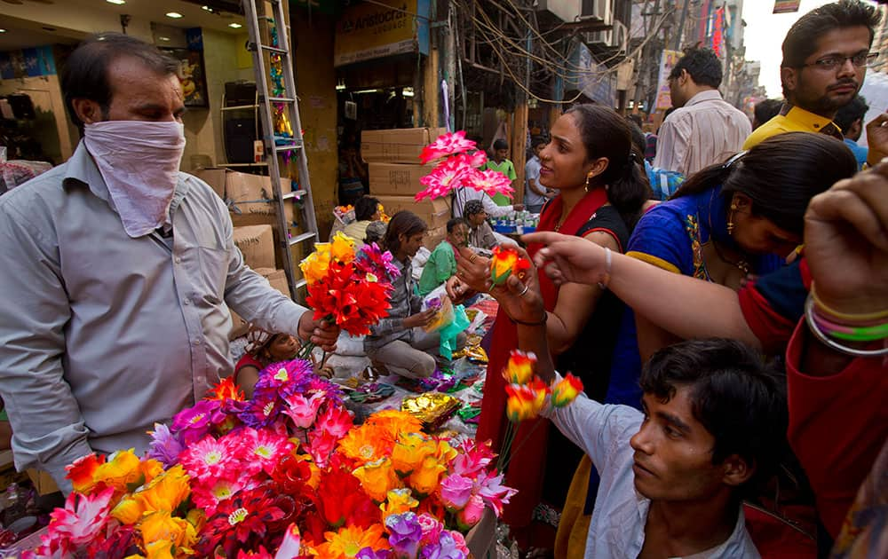 A woman buys plastic flowers to decorate her home on occasion of 'Diwali', the Hindu festival of lights, in New Delhi.