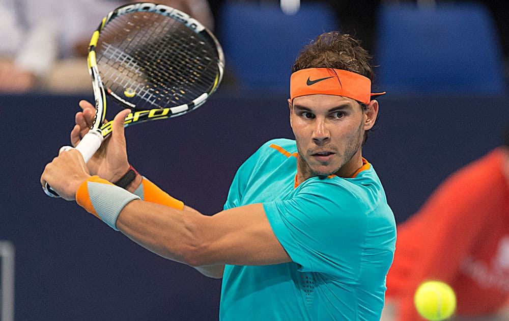 Spain's Rafael Nadal returns a ball to Italy's Simone Bolelli during their first round match in the Swiss Indoor tennis tournament at the St. Jakobshalle in Basel, Switzerland.