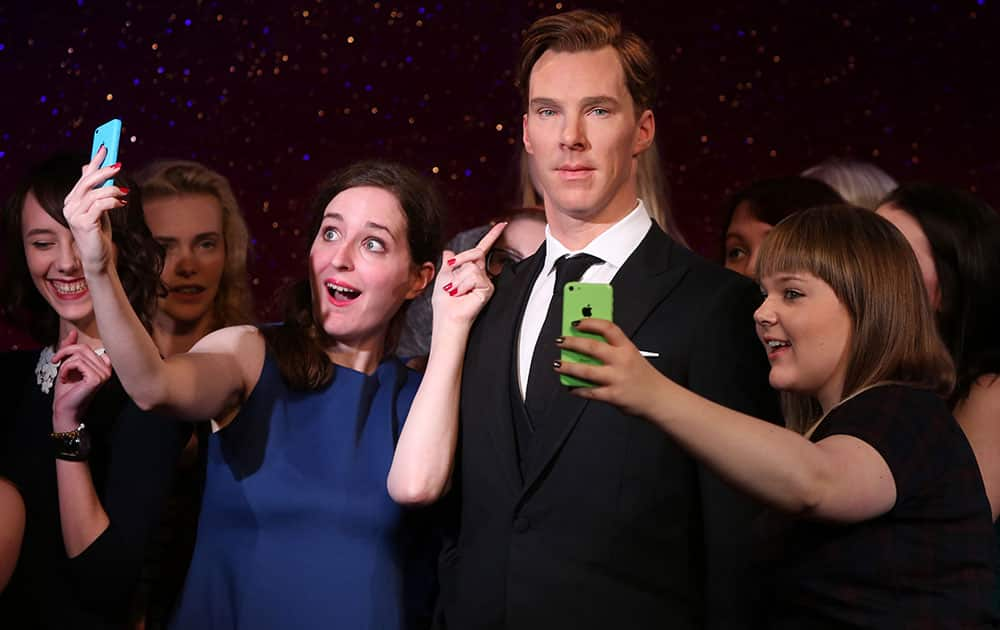 Fans takes selfies around the new wax figure of Benedict Cumberbatch as it is unveiled at Madame Tussauds in central London.