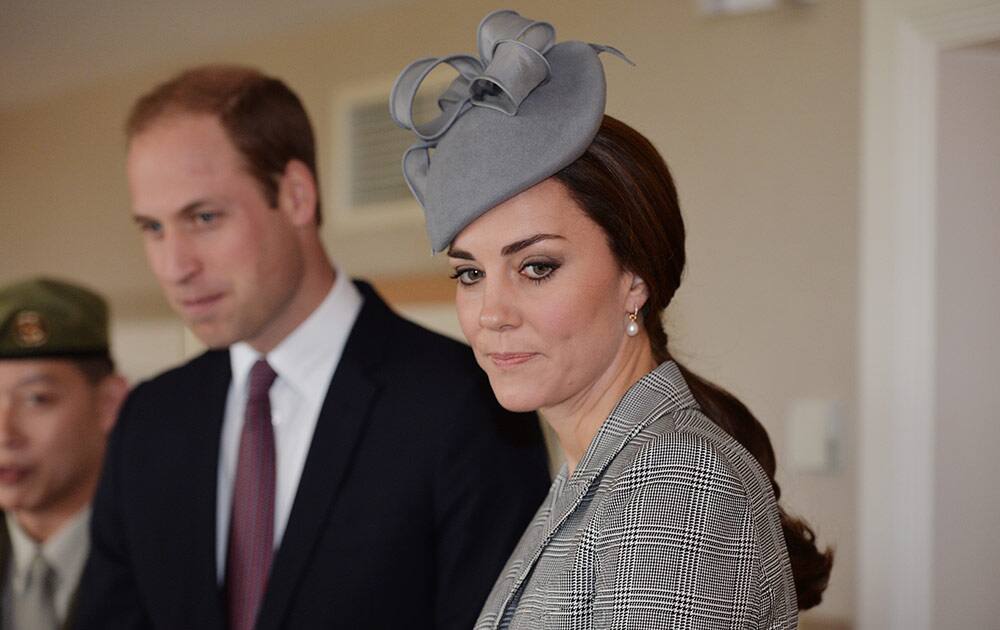 Britain's Prince William, and his wife, Kate, Duchess of Cambridge, wait to greet the President of Singapore, Tony Tan Keng Yam, and his wife Mary, at an hotel in London, on the first day of his four-day state visit to the Britain.