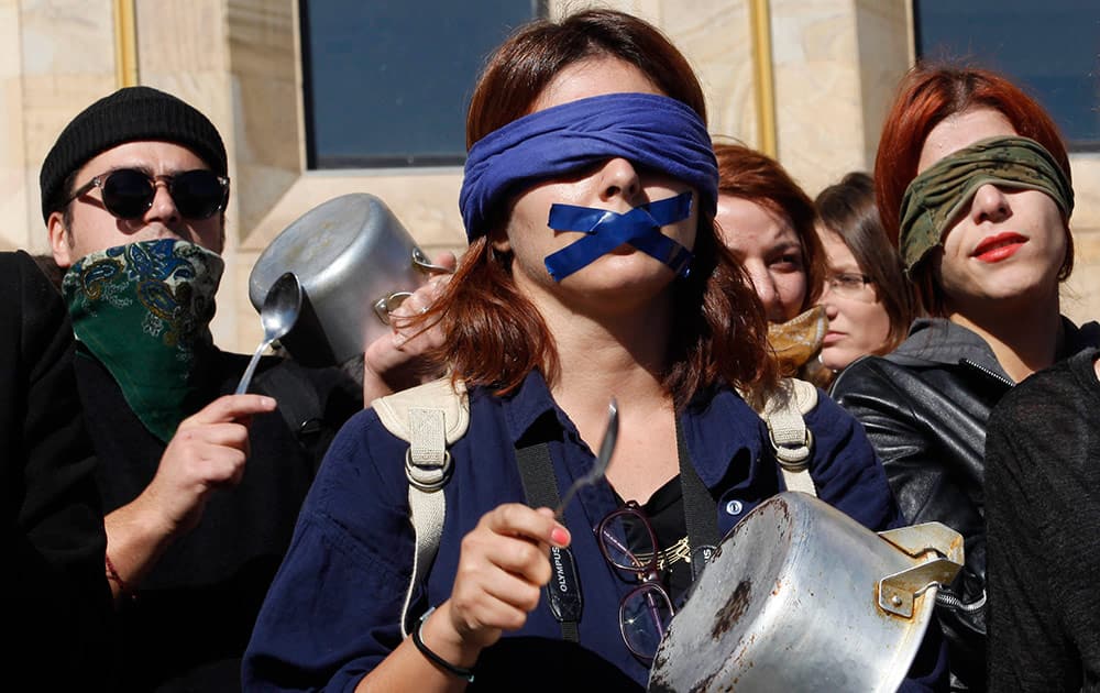 Demonstrators bang pots and pans as several hundred Georgian men and women gathered outside the Georgian government headquarters in Tbilisi, Georgia, for a protest rally as a part of a campaign called Stop That! against domestic violence in the country. 