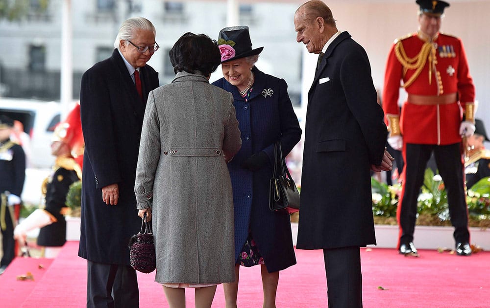 Britain's Queen Elizabeth and Prince Philip, greet the President of Singapore Tony Tan, and his wife Mary, during a ceremonial welcome at Horse Guards Parade in London .