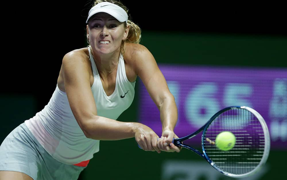 Russia's Maria Sharapova makes a backhand return to Denmark's Caroline Wozniacki during their singles match at the WTA tennis finals in Singapore.