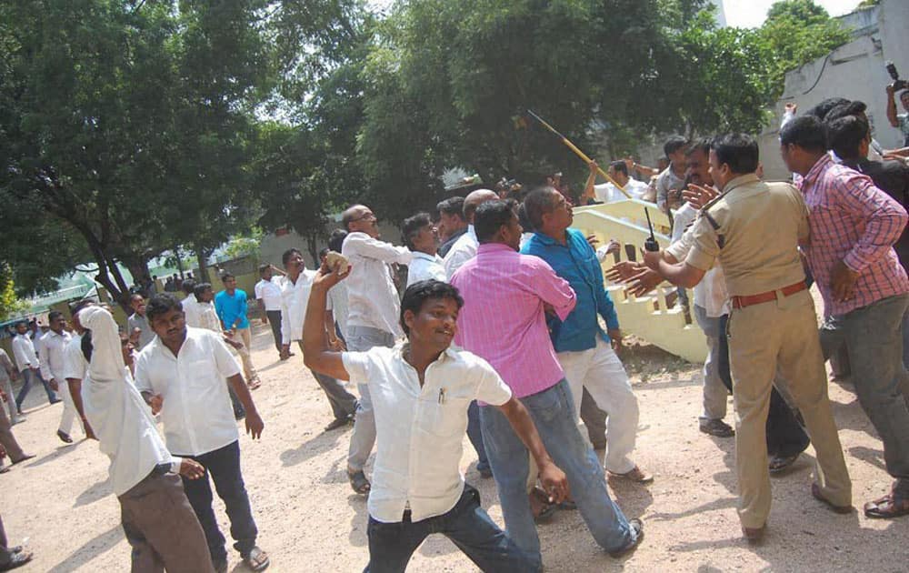 TRS activists attack at the TDP office in Nalgonda on Tuesday during a protest over the issue of power generation in Srisailam Project.