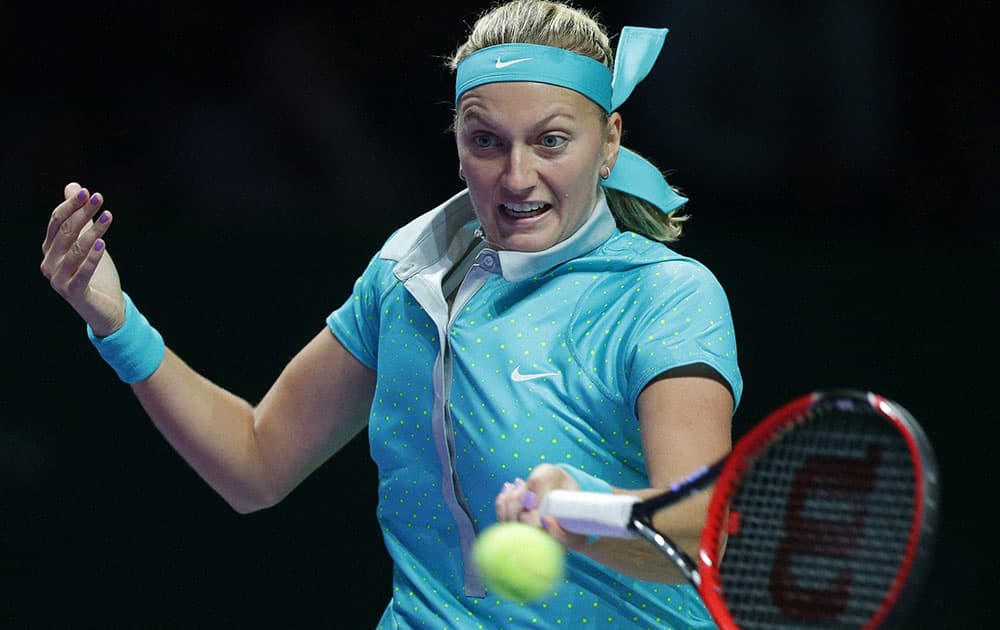 Petra Kvitov of the Czech Republic makes a forehand return to Polands Agnieszka Radwanska during their singles match at the WTA tennis finals in Singapore.