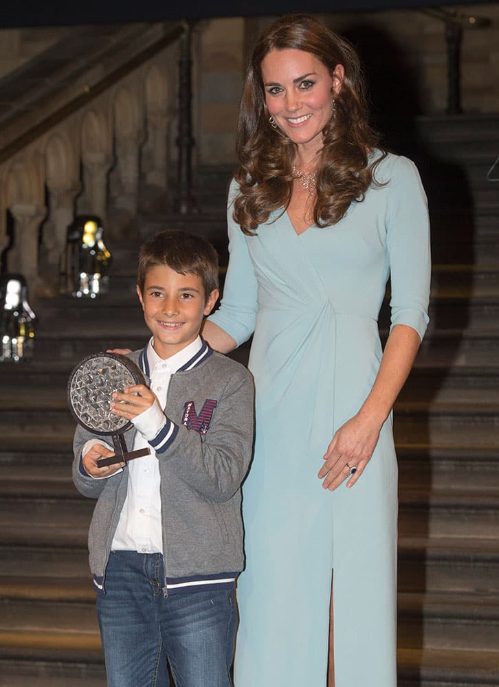 Britains Catherine Duchess of Cambridge poses for photographers with Young Wildlife Photographer of the Year Carlos Perez Navel, after the Wildlife Photographer of the Year 2014 awards ceremony at the Natural History Museum in London.
