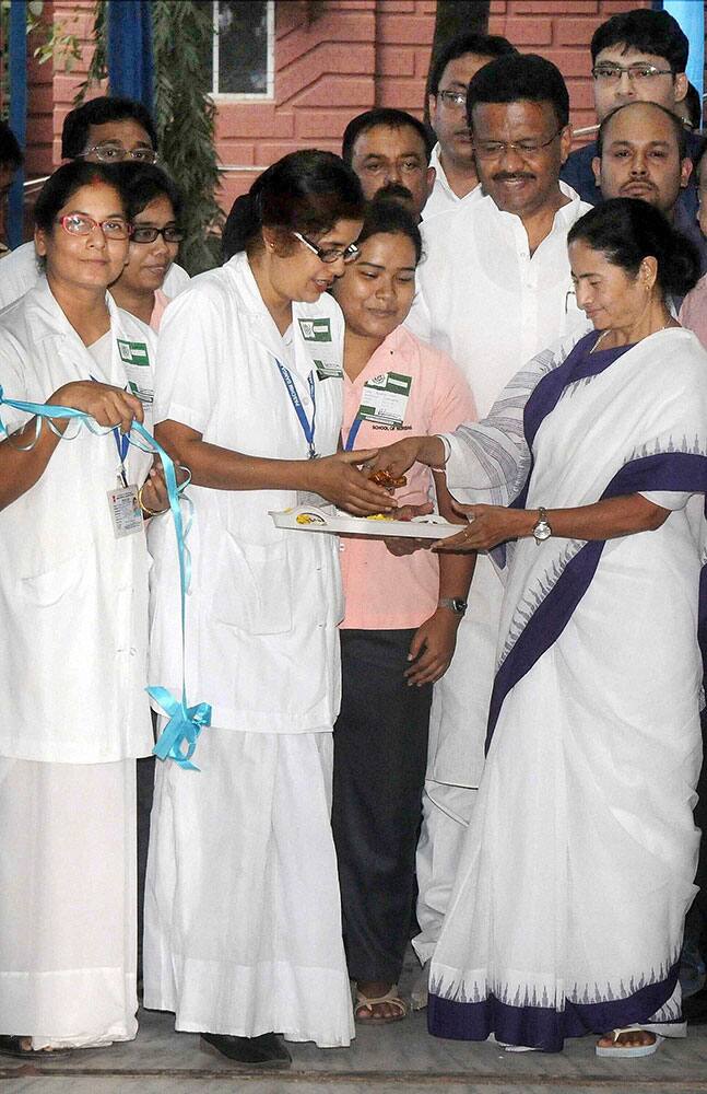 West Bengal Chief Minister Mamata Banerjee with the nurses during the inuaguration of academic building of Institute of Post Graduate Medicine Educational & Research (IPGME&R) of SSKM hospital and Government aided services for the other several hospitals, in Kolkata.