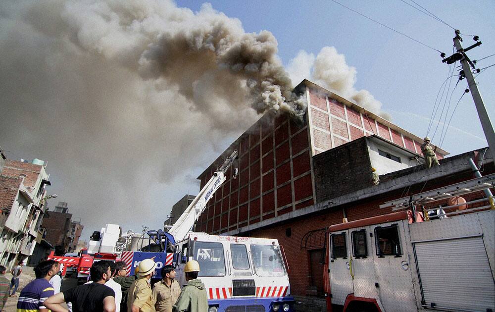 Fire fighters try to douse flames after a major fire broke out in a cold storage in Jammu.