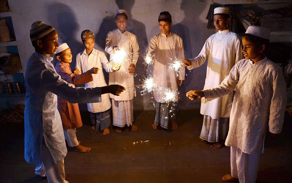 Muslim children celebrating Diwali with sparklers at a Madarsa in Mirzapur.