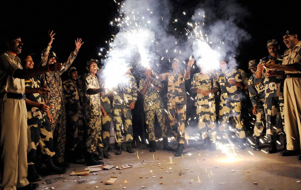 Border Security Force (BSF) soldiers enjoy Diwali celebrations on the eve of Diwali at the India-Bangladesh border post of Lankamura, about 5 kilometers (3 miles) from Agartala.
