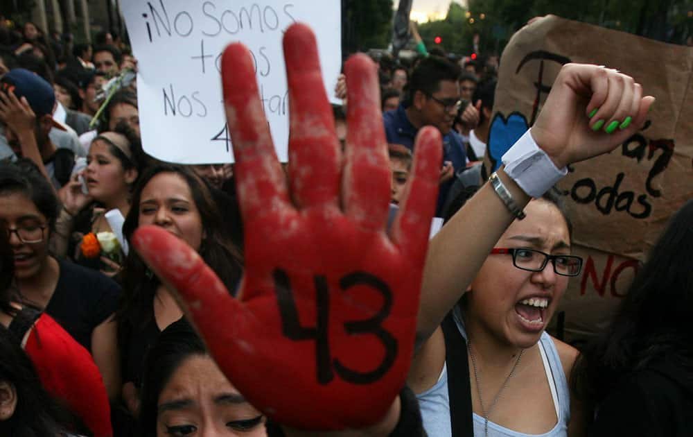 Demonstrators march in protest for the disappearance of 43 students from the Isidro Burgos rural teachers college, in Mexico City.