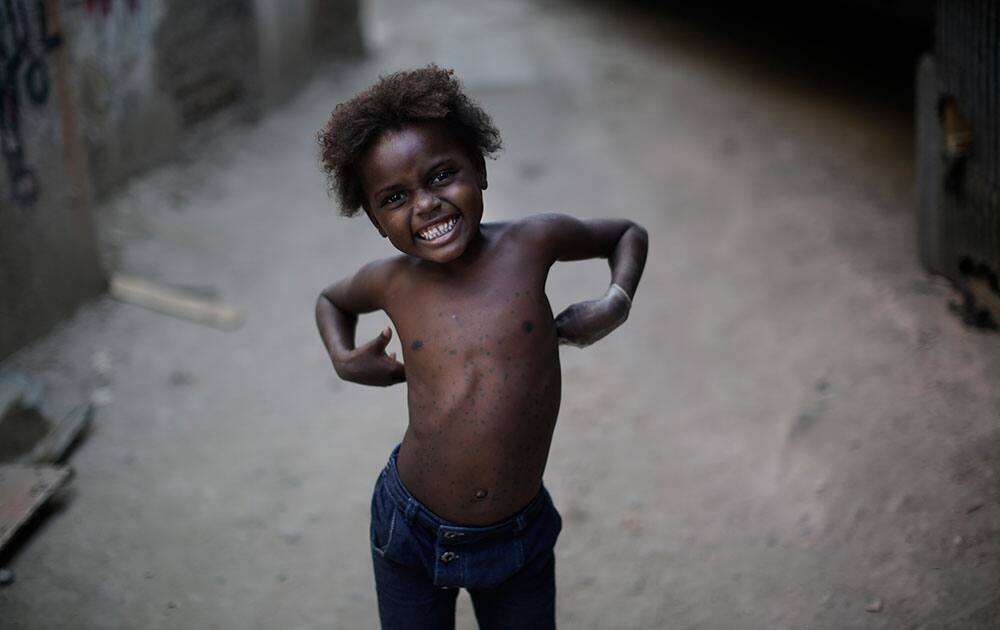 a little girl smiles to the camera as she plays in the McLaren area of the Mare slum complex in Rio de Janeiro, Brazil. While the circumstances of the poor remain dire, the lowest echelons of Brazil’s social pyramid have seen the net greatest improvement in their lives over the past decade during three successive Workers’ Party governments. 