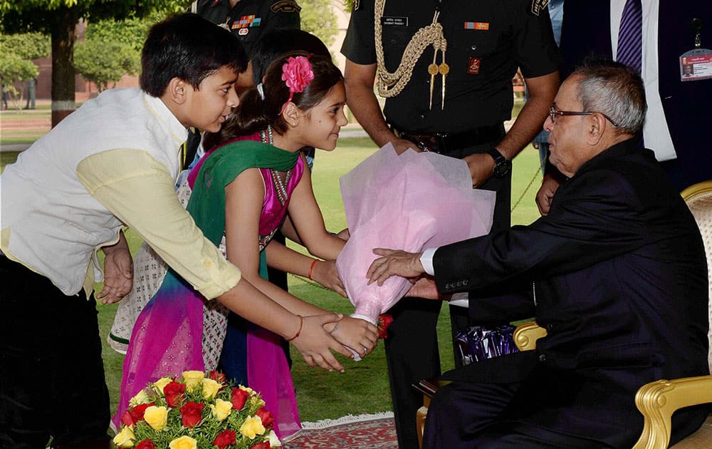 President Pranab Mukherjee being greeted by children on the occasion of Diwali at Rashtrapati Bhavan in New Delhi.