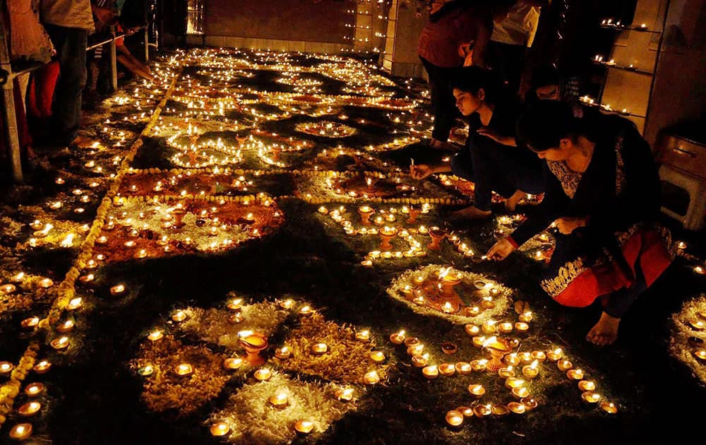 Devotees light lamps in Keshev Dev Temple premises during Diwali Festival celebration in Mathura.