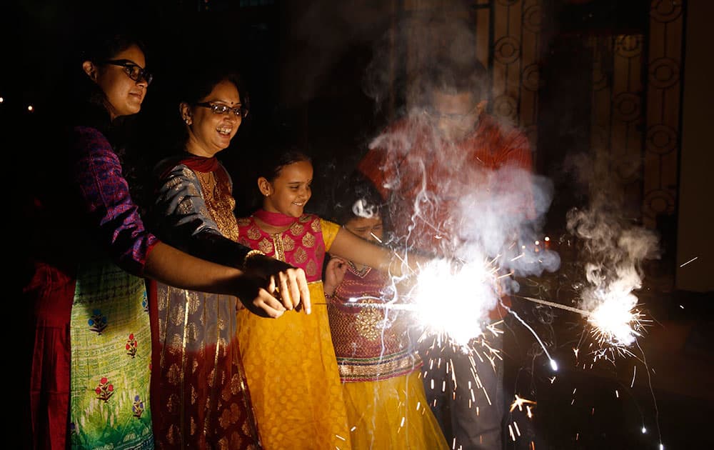 Indians play with firecrackers to celebrate Diwali in Allahabad, India.